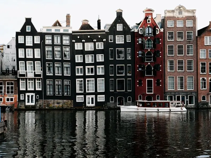 Canal houses reflected in the water in Amsterdam