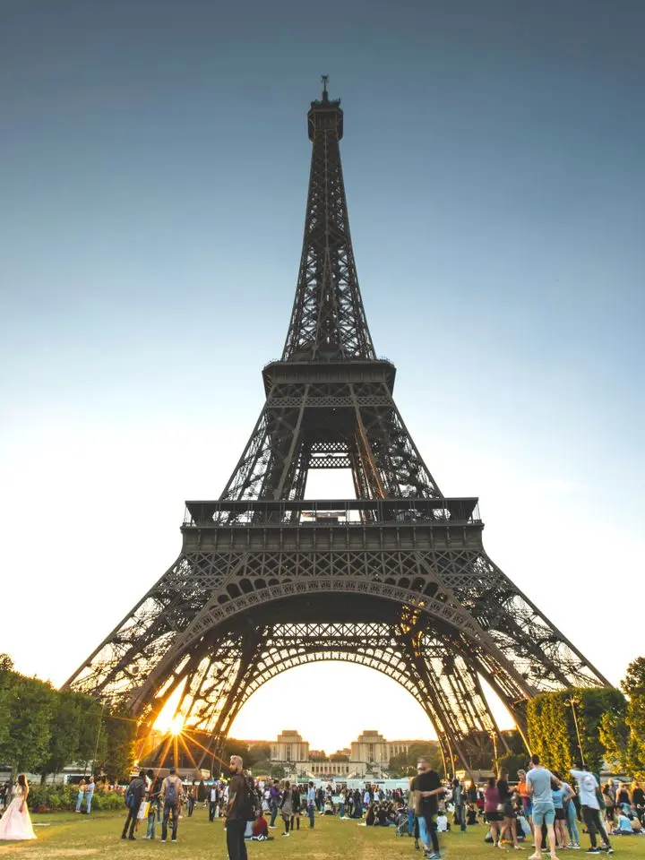 The Eiffel Tower at sunset seen from the Champ de Mars