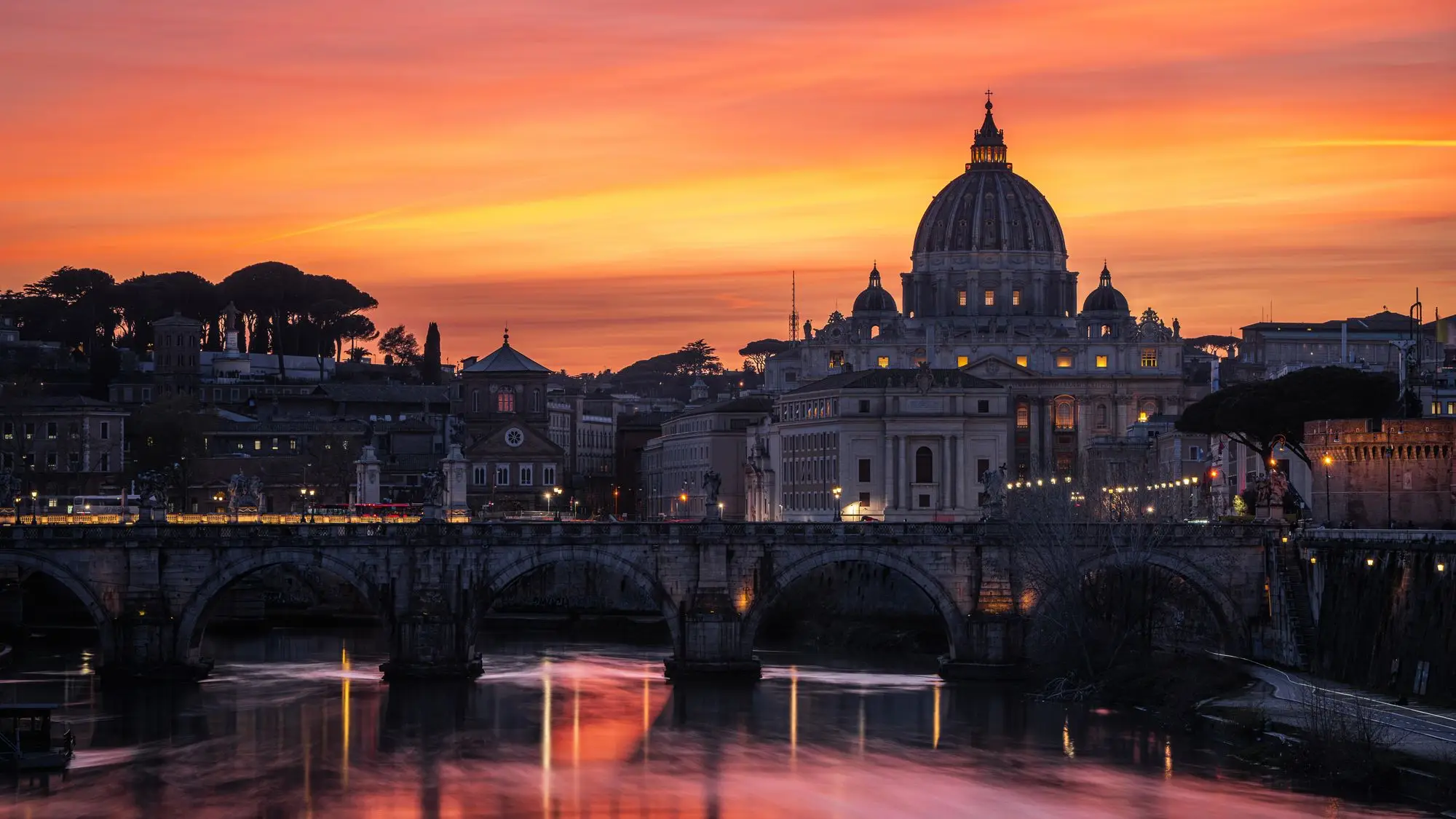 St Peter's Basilica and the Sant'Angelo bridge in Rome at sunset